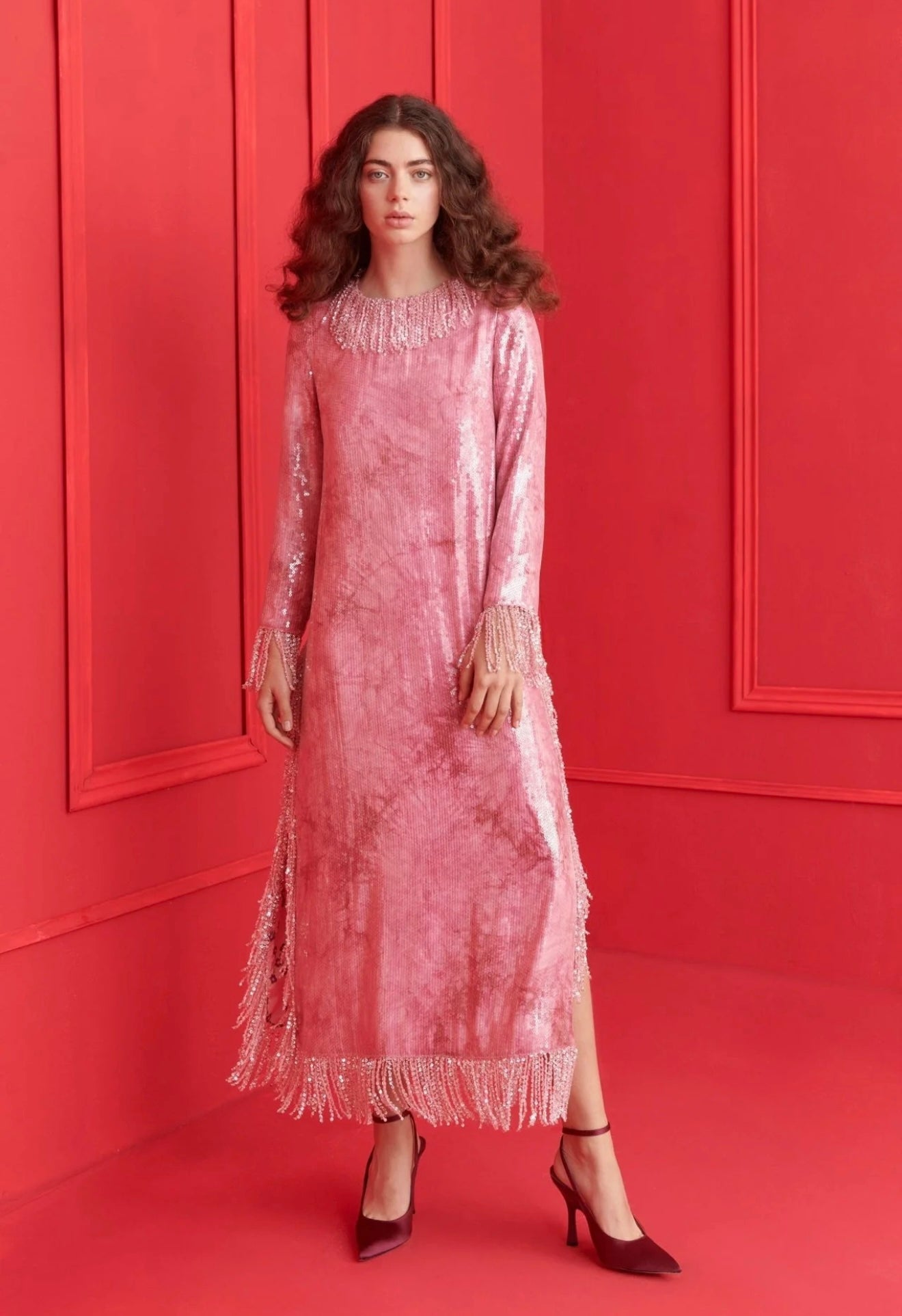 Elegant pink sequin dress with fringe sleeves and detailed neckline, perfect for special occasions.