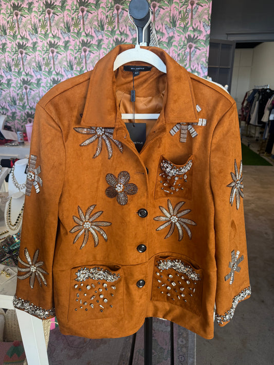 Vintage-style orange suede jacket with floral embellishments and rhinestones, featuring two front pockets.